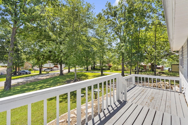 wooden terrace featuring a yard