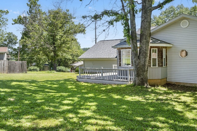 view of yard with fence and a wooden deck