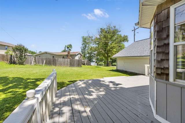 wooden terrace featuring a yard