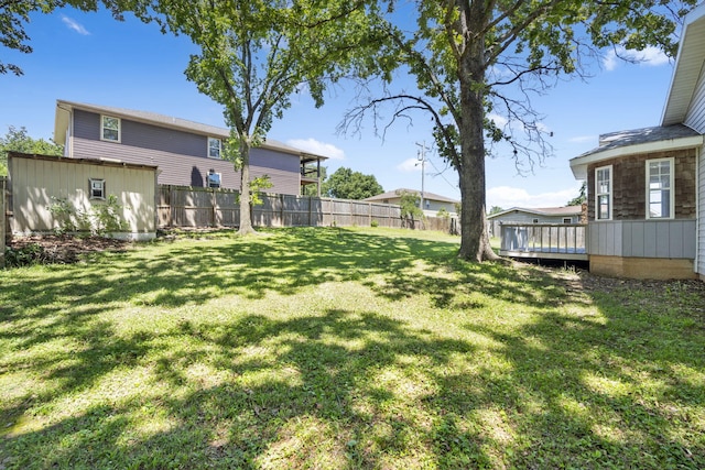 view of yard with fence and a deck