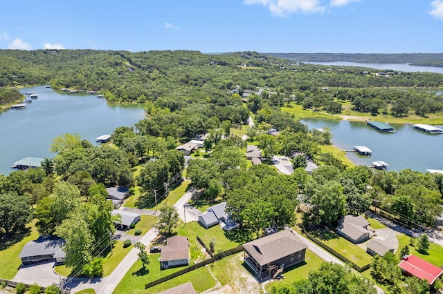 birds eye view of property featuring a water view, a residential view, and a view of trees