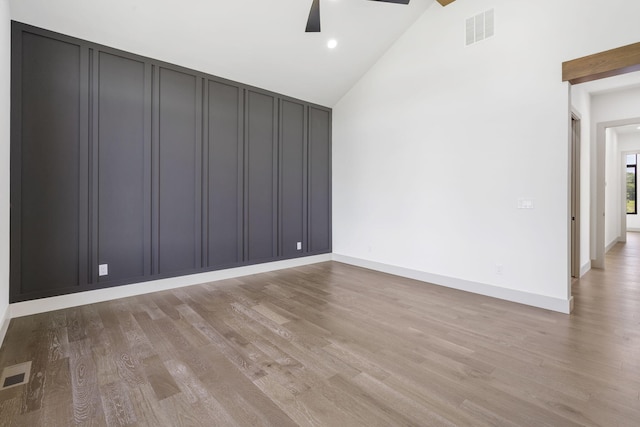 unfurnished room featuring ceiling fan, high vaulted ceiling, and light hardwood / wood-style flooring