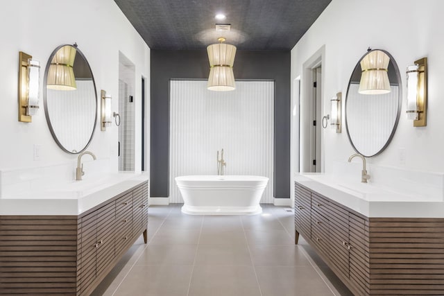 bathroom featuring tile patterned flooring, a bathtub, and vanity