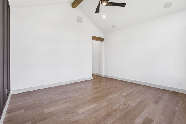 empty room featuring beam ceiling, ceiling fan, light hardwood / wood-style flooring, and high vaulted ceiling