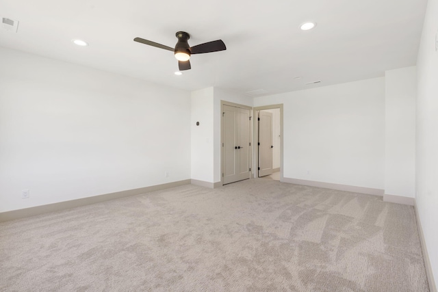 spare room with light carpet and ceiling fan