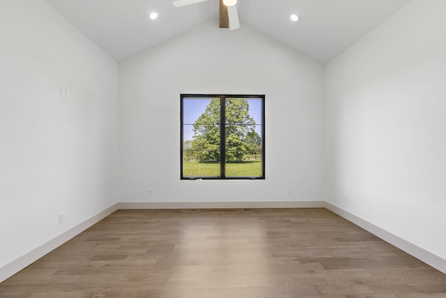 spare room featuring vaulted ceiling with beams, ceiling fan, and light wood-type flooring