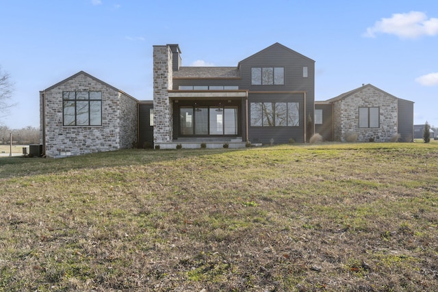 rear view of property featuring cooling unit and a yard