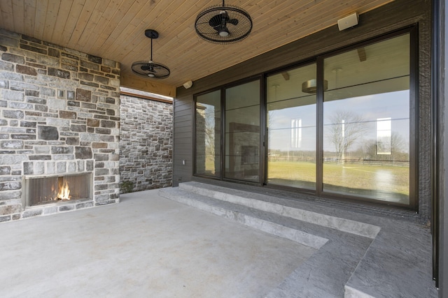 view of patio featuring an outdoor stone fireplace