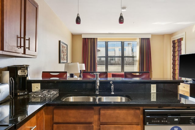 kitchen featuring white dishwasher, hanging light fixtures, sink, tasteful backsplash, and dark stone counters