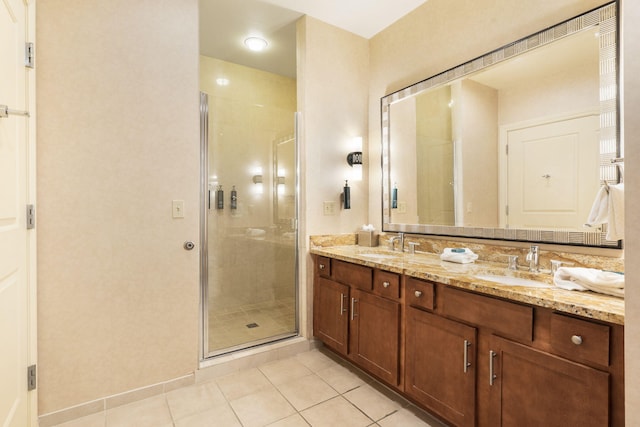 bathroom featuring vanity, a shower with door, and tile patterned floors