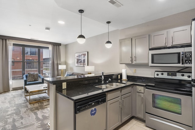 kitchen featuring appliances with stainless steel finishes, gray cabinetry, kitchen peninsula, and sink