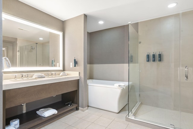 bathroom featuring independent shower and bath, vanity, and tile patterned flooring