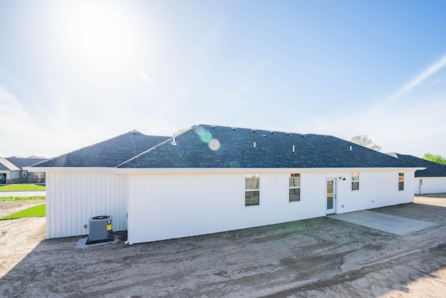 back of property with cooling unit and a patio area