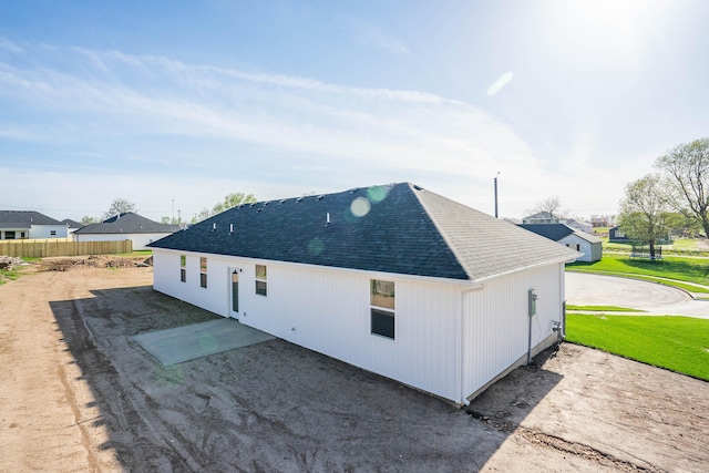 view of home's exterior with a yard and a patio