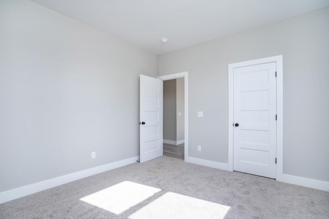 unfurnished bedroom with a closet and light carpet