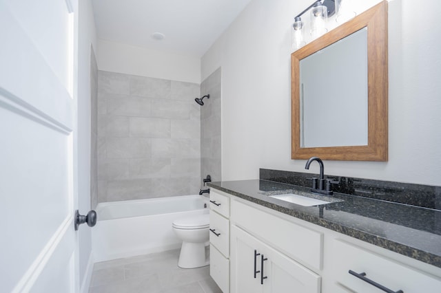 full bathroom featuring toilet, vanity, and tiled shower / bath