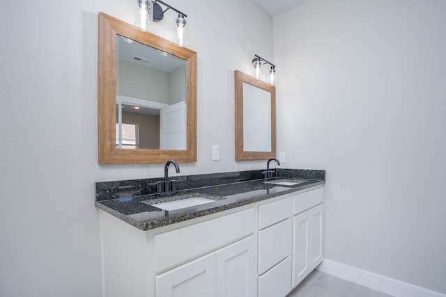 bathroom with tile patterned flooring and vanity