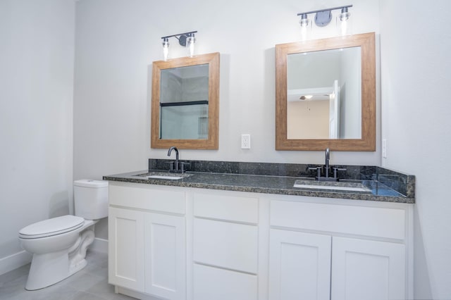 bathroom featuring vanity, tile patterned flooring, and toilet