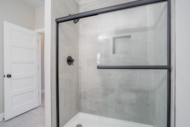 bathroom featuring a shower with shower door