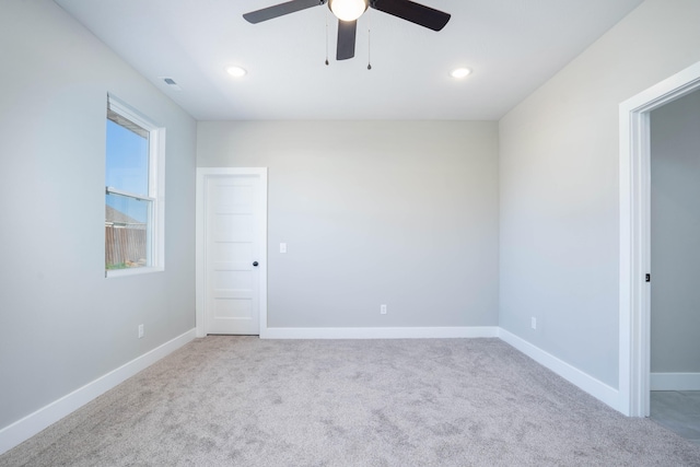 carpeted spare room with ceiling fan