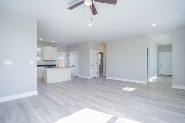 unfurnished living room with ceiling fan and light hardwood / wood-style floors