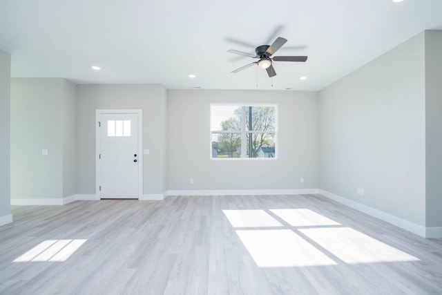 unfurnished living room featuring light wood-type flooring and ceiling fan