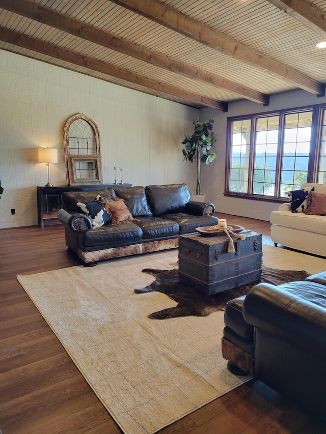 living room featuring beamed ceiling, wooden walls, and hardwood / wood-style floors