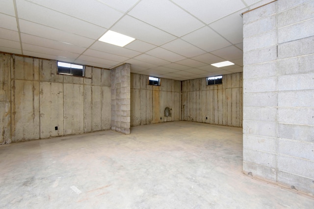 basement with a paneled ceiling