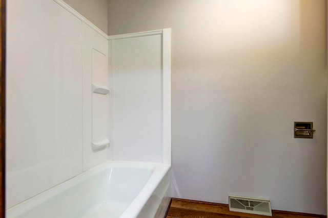 bathroom featuring a tub and hardwood / wood-style floors