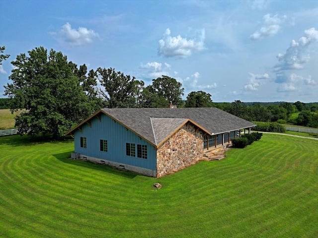 view of side of home with a lawn