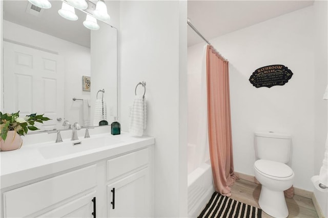 full bathroom with vanity, hardwood / wood-style floors, toilet, and shower / tub combo with curtain