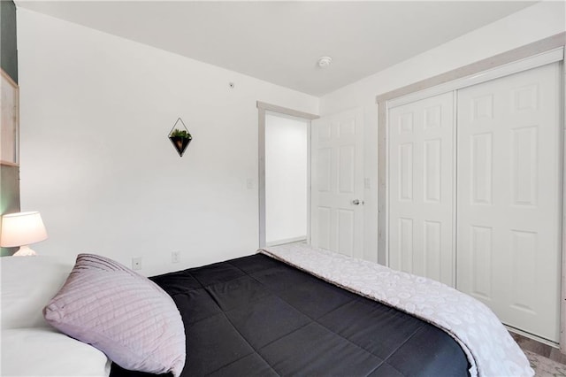 bedroom with hardwood / wood-style flooring and a closet