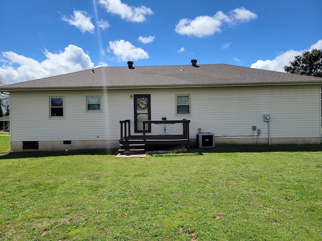 back of house with a lawn, roof with shingles, and central AC