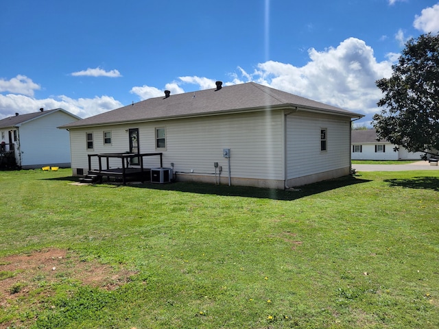 back of property with a lawn