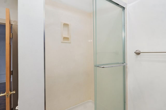 bathroom with a shower with door