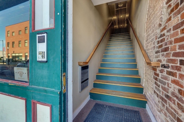 staircase with brick wall