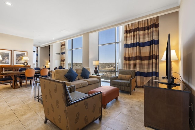 living room with crown molding, a wall of windows, and light tile patterned floors