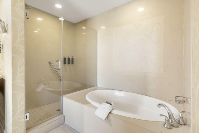 bathroom featuring plus walk in shower, tile patterned floors, and tile walls