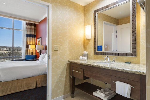 bathroom with ornamental molding and vanity