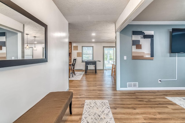 hallway featuring a textured ceiling and hardwood / wood-style flooring