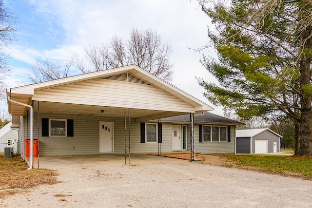 view of front of home featuring a garage, cooling unit, an outbuilding, and covered porch