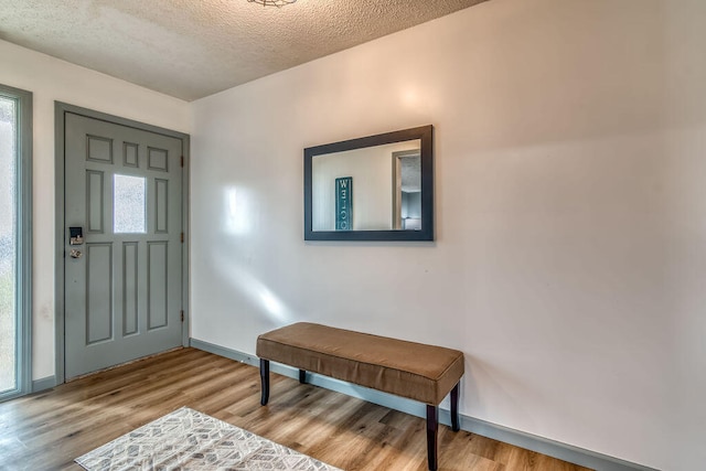 entrance foyer with light hardwood / wood-style flooring and a textured ceiling