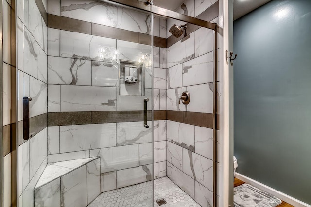 bathroom with a shower with door