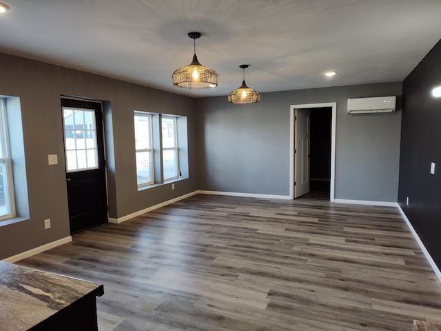 interior space featuring dark hardwood / wood-style floors and an AC wall unit