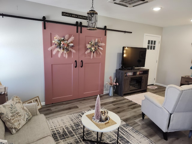 living room with hardwood / wood-style floors and a barn door