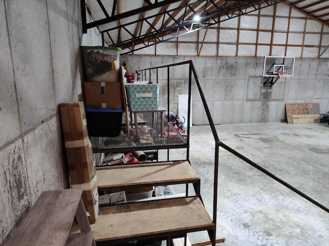 stairway with concrete flooring and vaulted ceiling