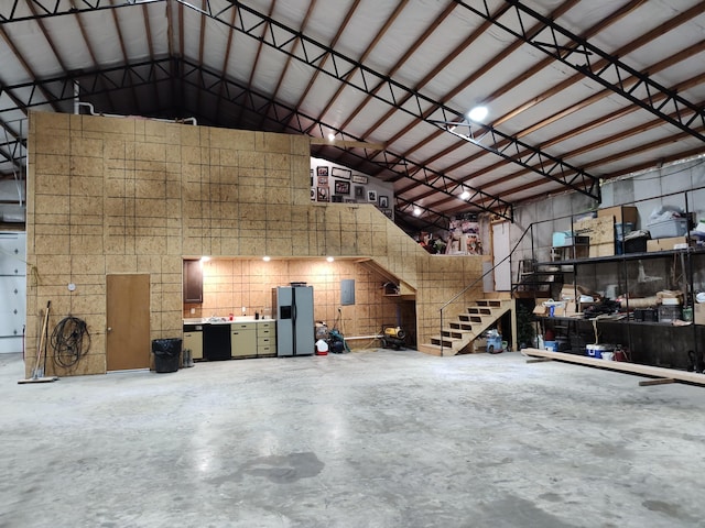 garage with stainless steel fridge