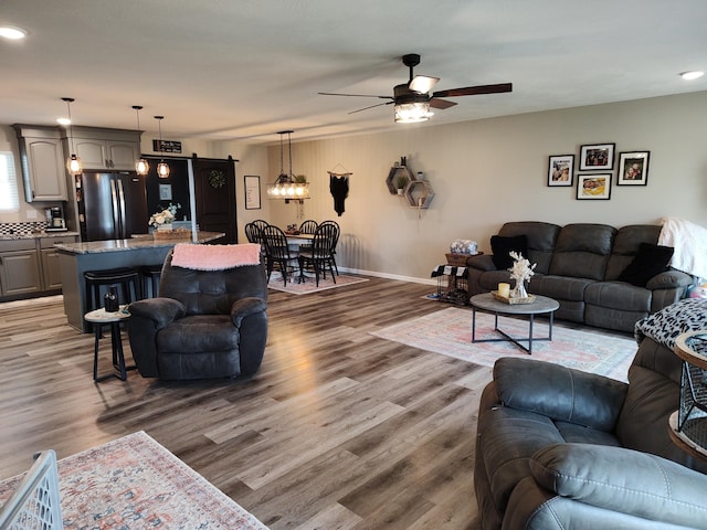 living room with hardwood / wood-style floors and ceiling fan