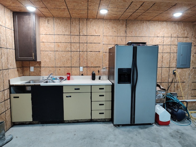 kitchen with electric panel, stainless steel refrigerator with ice dispenser, and sink