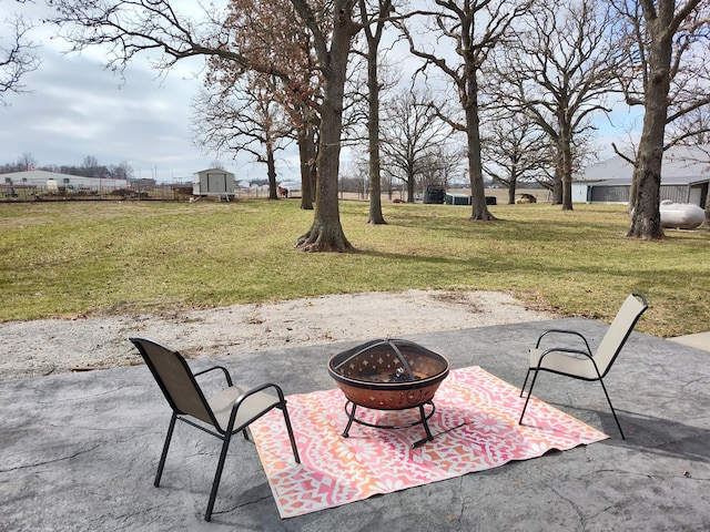 view of patio with a fire pit and a storage shed